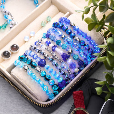 NOGU The Blue Edit beaded bracelets in deep blue, turquoise and iridescent crystal beads, displayed in a velvet jewelry case.