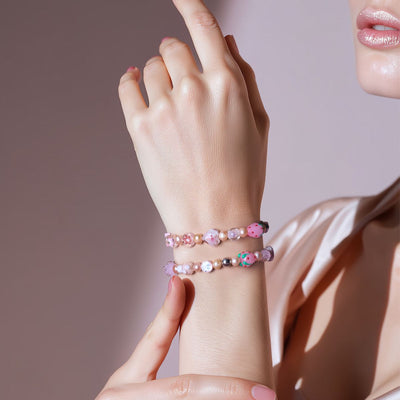 NOGU Strawberry Frost pink beaded bracelet stack with frosted berry-inspired charms and soft pearly accents.