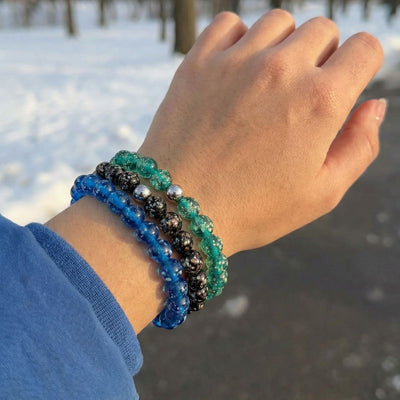 NOGU Made to Pair Teal Firefly stack with teal, cobalt blue and black glass bead bracelets with silver-tone accents.