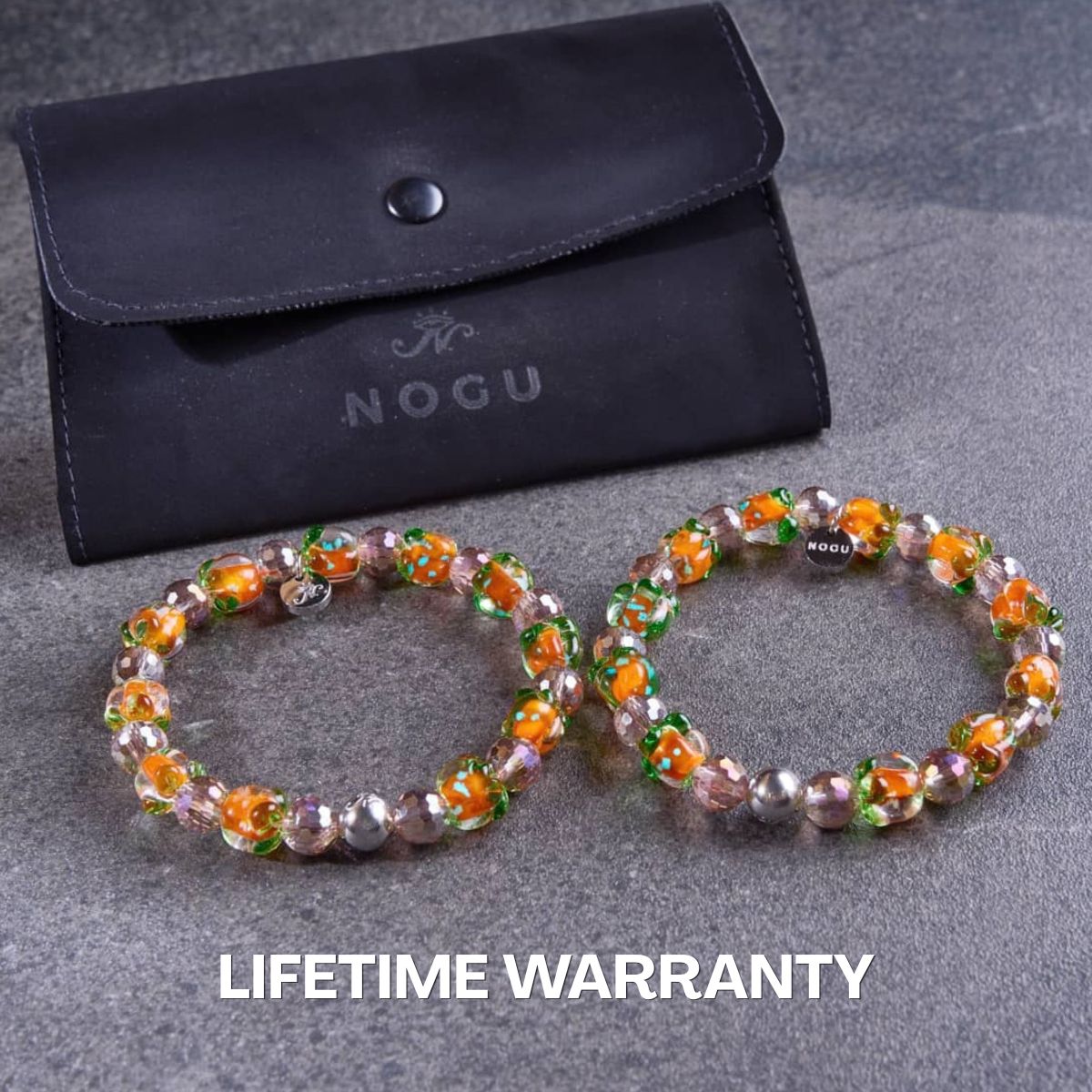 Pair of NOGU beaded stretch bracelets with orange floral glass beads, purple faceted crystals and silver-tone accents.