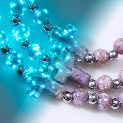 Periwinkle Firefly Glass Cross Bracelet with glowing glass beads and silver stainless steel accents by NOGU