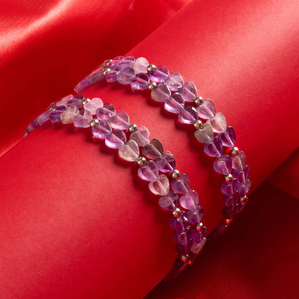Amethyst | double-wrap bracelet with heart-shaped purple amethyst beads and silver round spacers on red background by NOGU