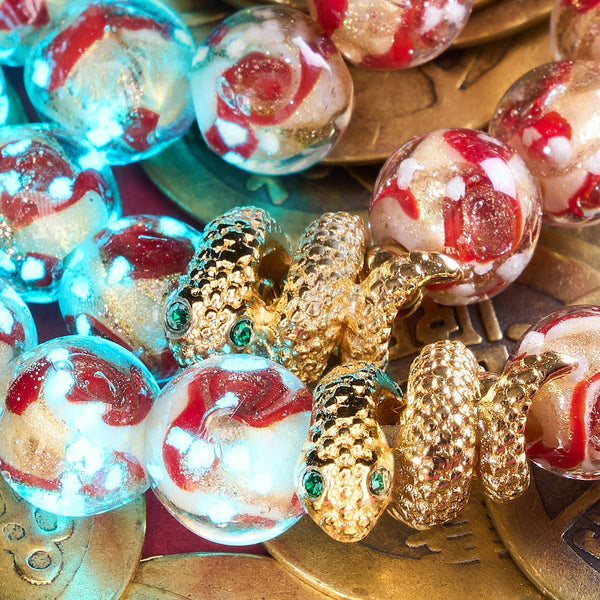 Golden Snake Firefly Glass Swirl Bracelet with glowing red and gold beads and detailed 18k gold-plated snake charm by NOGU