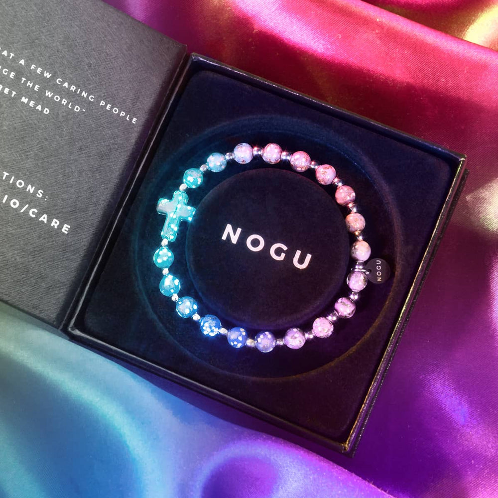 Periwinkle Firefly Glass Cross Bracelet glowing blue and purple beads in black NOGU box with silver accents
