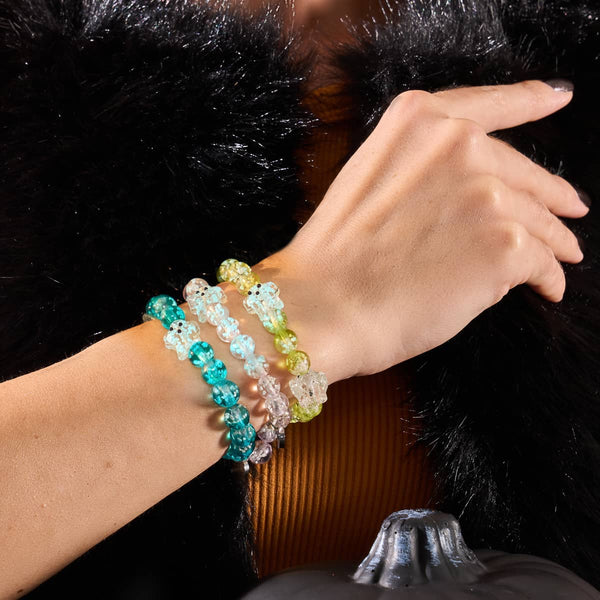 Teal Phantom bracelet with teal Firefly Glass ghost beads on silver-plated stainless steel base worn alongside other color bracelets by NOGU