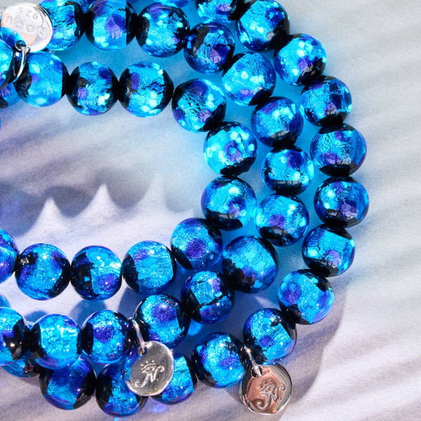 Blue Astra bracelets with sparkling blue Solar Glass beads and sterling silver logo charms by NOGU