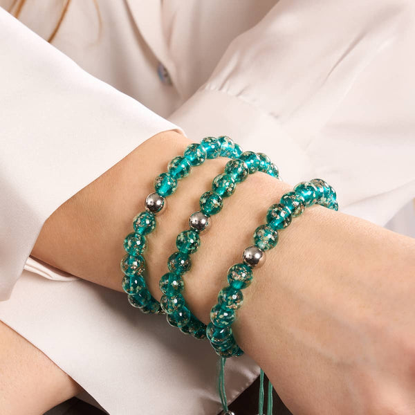 Teal silver Firefly glass macrame bracelets with stainless steel beads stacked on wrist by NOGU